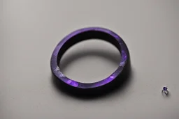 небольшое чёрное кольцо с лиловым камнем выпало на пол.