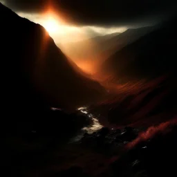 atmospheric deep orange light coming through a dark valley