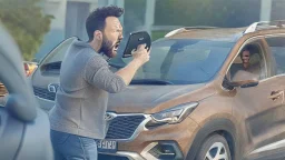 guy arguing on cellphone next to his kia sportage