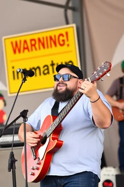 a very immature adult man playing music, cartman south park, sign in background that says "Warning!" "immature"