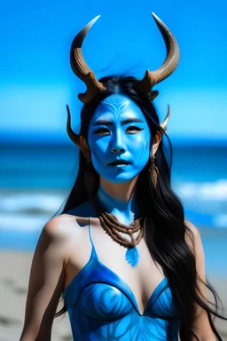 A photo of a blue skin asian goddess with painted blue face and body skin, wavy black hair deer antler horns, standing on a sunny beach