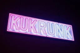 A 1980 disco sign labeled "KUKRUNK" white background and bold 80s font