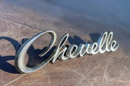 "Chevelle" nameplate 3d metal with shadow, on top of scratched wood surface