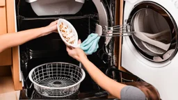 woman puts spoons in the dryer