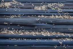 small clusters of tiny sand grains spread out over Navy Blue driftwood planks Background