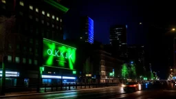 a billboard branded writing ODK , with neon light green and white , in the city center, at night . At Montréal