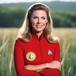 A realistic photo of Elizabeth Montgomery in an original “Star Trek” uniform. She is shown waist up. She is wearing a long sleeved red shirt with the two gold braids on the sleeves. She is holding a tricorder. She is smiling. The background is a field of grass.