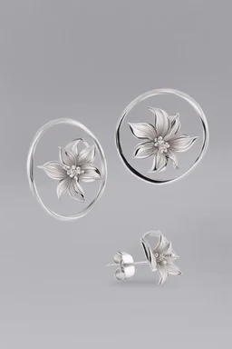 Small white gold earrings in the shape of a circular ring engraved with tiger lily flower