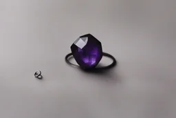 небольшое чёрное кольцо с лиловым камнем выпало на пол.