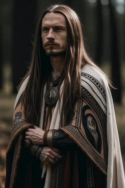 clean shaven long haired warrior with tribal tattoos and cloak