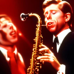 eyes closed REd-haired ron howard as richie from happy days Is playing the saxophone with his "eyes closed", rock band, saxophone To lips, looking at camera