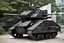 Placeholder: Rabbit mecha. It is black and very tank-like. Photograph.