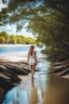 Placeholder: beautiful girl walking to camera in trees next to wavy river with clear water and nice sands in floor