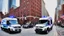 Placeholder: A police Tesla Cybertruck is chasing a Tesla 'Model S Plaid' at top speed, on the South Street Seaport, in New York. CINEMATIC. WIDE ANGLE LENS. PHOTO REAL.
