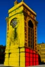 Placeholder: A golden yellow clock tower covered in acid painted by Keith Haring