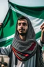 Placeholder: A young man stands and holds a large Palestinian flag in his hands and waves it while wearing a keffiyeh