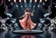 Placeholder: a 3d fractal stage made of metallic dark color 3d structures, pertty artistc background,dynamic animating lights,a beautiful lady prance in pretty maxi skirt and blouse dancing on stage