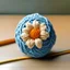 Placeholder: flower-shaped wool ball, crossed by two crochet hooks. front view