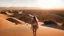 Placeholder: As I gaze out at the endless dunes, I am in awe of the beauty of the desert. The ground beneath me is warm and the sun shines brightly overhead. #outdoor #woman #summer