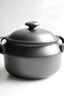 Placeholder: dark gray Dutch oven, flower shape, soft light, white background