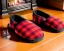 Placeholder: Red plaid slippers, bear rug,log cabin fireplace