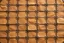 Placeholder: canvas background covered with a grid of many rectangular weathered faded tan leather patches that are each stitched (brown) and nailed (brass) around the edges