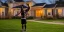Placeholder: A swole black man lifting dumbells in front of his house at twilight