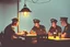 Placeholder: Smoky pub, cheerful young men drinking around a table, a policeman looking thoughtfully at the ID card of one of the boys, lantern light