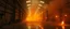 Placeholder: A cavernous industrial warehouse becomes a fever-dream carnival of fire and smoke, lit exclusively by erratic strobes and the orange glow of unpredictable blazes. The world is drenched in soot, haze, and manic energy — walls drip with condensation, fire extinguishers become absurd props, and every surface reflects the flicker of flames being born and killed in seconds. The visual journey spirals from controlled chaos to full unhinged delirium, with the camera lurching and spinning as if possesse
