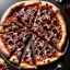 Placeholder: pizza with chocolate, black table