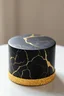 Placeholder: Ultra-realistic petite single-tier cake for 4 (short, squat, only 2–3 inches tall). Round. Smooth black fondant with elegant gold marble veining, evenly distributed like polished marble tile (natural, medium veins, not dense, not patchy, no large bare areas). Bottom edge has a thin 1 cm rim of sparkling gold foil flakes (shimmering, textured, light-catching). Modern, classy, no topper. Side + angled top view. Neutral lighting.