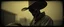 Placeholder: STYLE: gritty 19th-century gothic photography, Zdzisław Beksiński surrealism, Caravaggio chiaroscuro, tactile analog grain, pinhole-camera softness, heavy vignetting, scratched emulsion, rugged irregular photo border. SCENE: alien cowboy, completely absorbed in the mundane task.