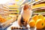 Placeholder: cute contented cat is shopping in a foodstore in sunshine. Food, fruits