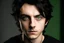 Placeholder: a young white male with messy black hair and green eyes