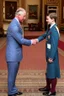 Placeholder: The Prince of Wales in traditional dress shakes hands with a young guest dressed in a blue suit, drawing room of St James's Palace, during a reception