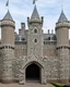 Placeholder: A light gray castle made out of bricks designed in medieval tapestry painted by Piet Mondrian