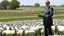 Placeholder: barack obama at podium speaking to large field of sheep