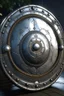 Placeholder: A round, silver shield that makes its wielder easier to heal, makes its wielder more accurate and helps its wielder find their foes.