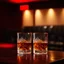 Placeholder: a table showing two whisky glasses in a dark room, red hues