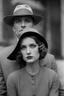 Placeholder: Up close Black and white photo of a serious couple sitting for portrait shoot in the 1920s