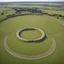 Placeholder: Close similarities have been noted between Stonehenge and Pömmelte circular enclosure in central Germany, which was built by Bell Beaker people around 2300 BC.[127] [121] Large timber circles in Britain such as Woodhenge, near to Stonehenge, have similarly been dated to the early Beaker period or just before the Beaker period.[182][183] Some researchers have suggested that Woodhenge may have been a monumental roofed building, though it is usually thought to have been an open-air structure.[184][