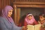 Placeholder: A close-up scene of an Arab mother reading the story from a book with her children around her in the room of the old wooden house near the fireplace 100 years ago.