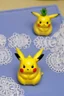 Placeholder: cute and nice faced marzipan Pikachu on a lace blanket on a kitchen table