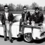 Placeholder: a 50s Greaser ROCK BAND standing in front of a hot rod