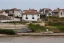 Placeholder: a modern village on a small island on the coast of France. The village is beeing flooded slowly by the sea rising. Some house are abandoned but most people stayed in the village.