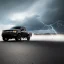 Placeholder: hyperrealistic shot, speeding 4x4 black truck, monotone color palette, sharp focus, puddle reflec1tion, tire mud splashes, refraction, huge boulders backdrop, mist on the horizon, thunder and lightning, overcast shadow, detailed and intricate, cinematic composition, 8k, micro, tilt shift photography, bokeh