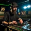 Placeholder: A short brown beard, DJ board,man with a baseball hat sing at microphone, many electronic consoles studio , microphones,, laser lights, FRONT VIEW