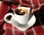 Placeholder: Cappuccino art microfoam in houndstooth mug saucer Crawford plaid napkin Demitasse