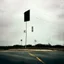 Placeholder: Minimal contemporary abstract oil paintings of desolate 1960s carpark with road markings and concrete fragments. Overlay with grungy typography graphics. style of Justin Mortimer and Francis Bacon.