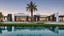 Placeholder: Description of a modern Emirati style villa: Located on a magnificent piece of land in the heart of the Emirates, our villa embodies the finesse of design and detailing that promises a luxurious residential experience. This two-story villa, with its elegant and contemporary spaces, stands out. The exterior walls of the villa are made of black and white stones, adding an elegant and luxurious touch to the design.Pictures of the villa from four sides